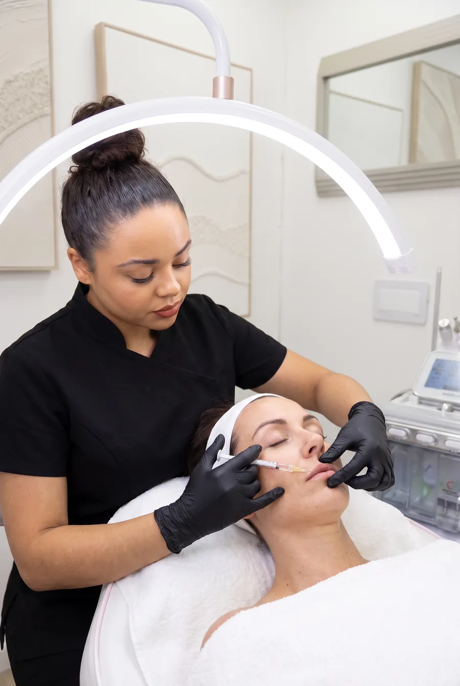 Chelsea performing a lip filler treatment